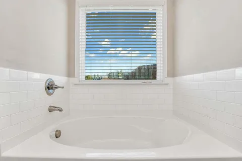 a white bath tub sitting next to a window