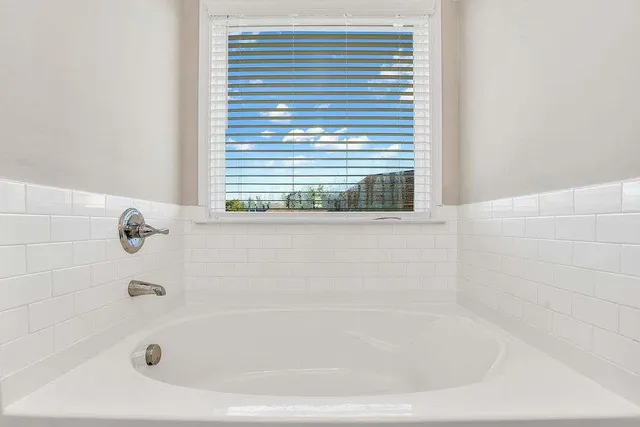 a white bath tub sitting next to a window