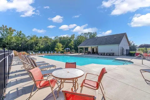 a view of a patio with table and chairs with wooden floor and fence