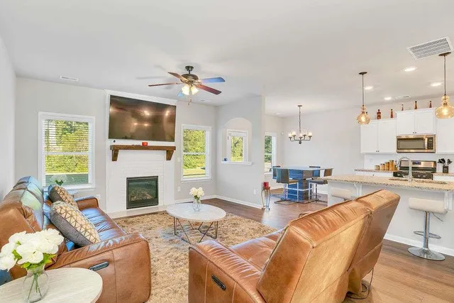 a living room with furniture a flat screen tv and a fireplace