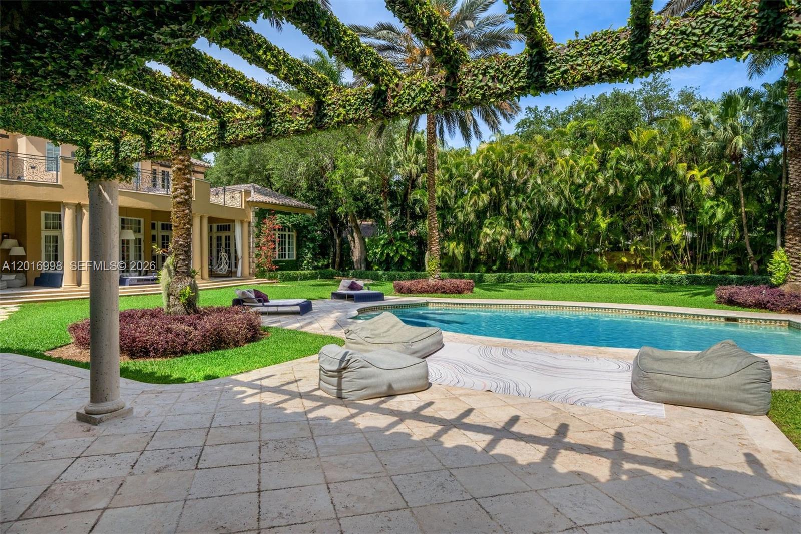 4790 Southwest 78th Street Miami, FL 33143 - Photo 27 of 33 a view of a house with a patio and a garden