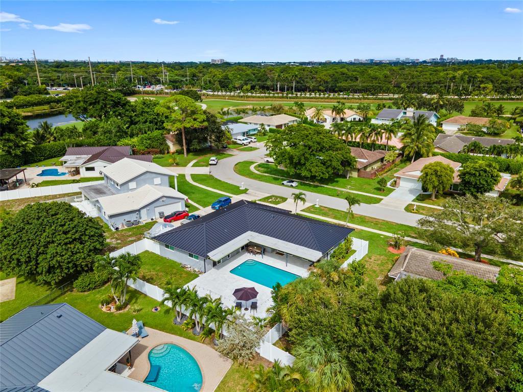 an aerial view of residential houses with outdoor space and river