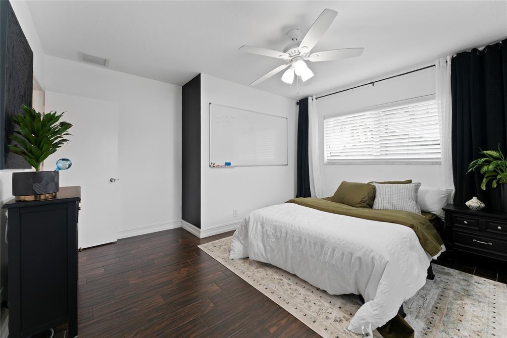 22111 Serenata Circle West Boca Raton, FL 33433 - Photo 13 of 18 a bedroom with a bed and wooden floor