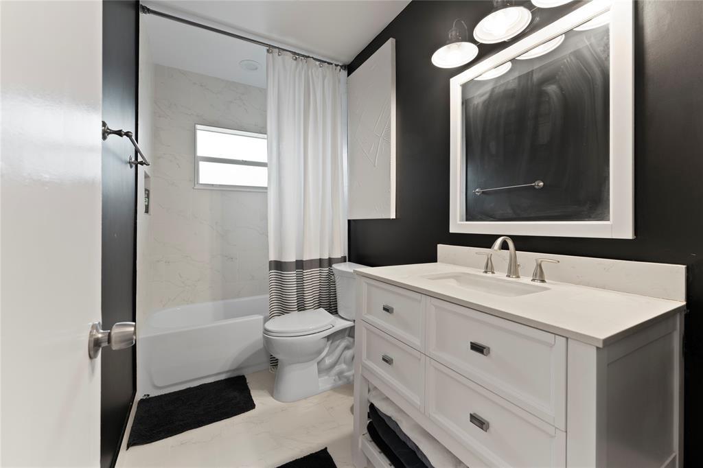 22111 Serenata Circle West Boca Raton, FL 33433 - Photo 14 of 18 a bathroom with a sink a toilet a mirror and shower