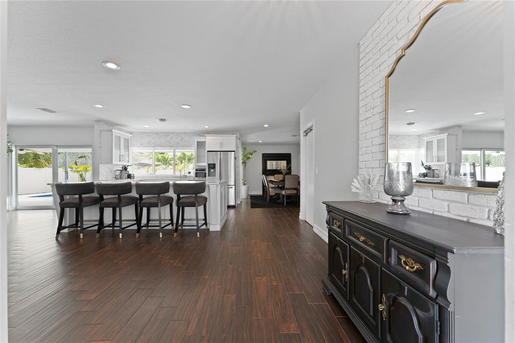 22111 Serenata Circle West Boca Raton, FL 33433 - Photo 4 of 18 a kitchen with stainless steel appliances a dining table chairs and wooden floor