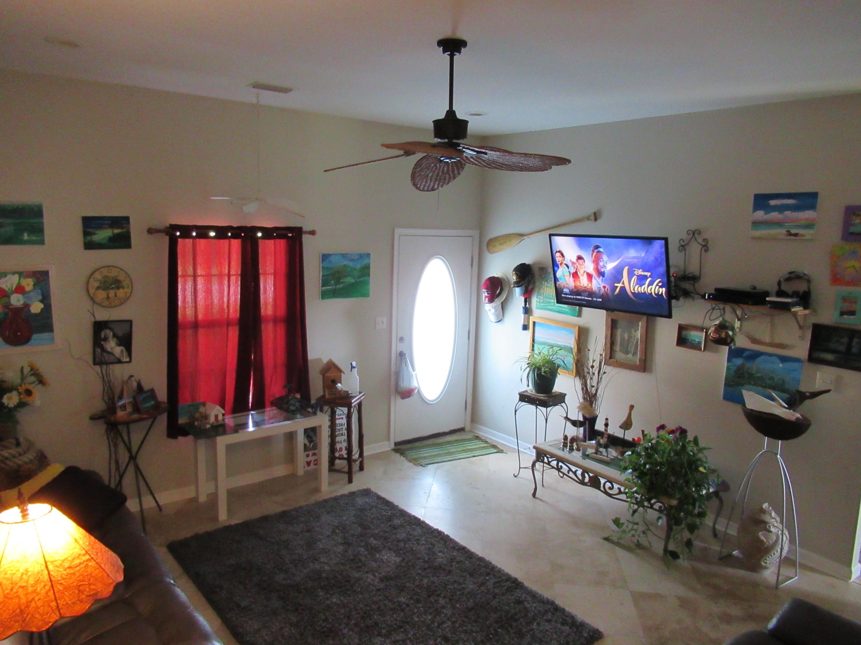 305 Tropical Way Freeport, FL 32439 - Photo 3 of 17 a living room with furniture and a flat screen tv