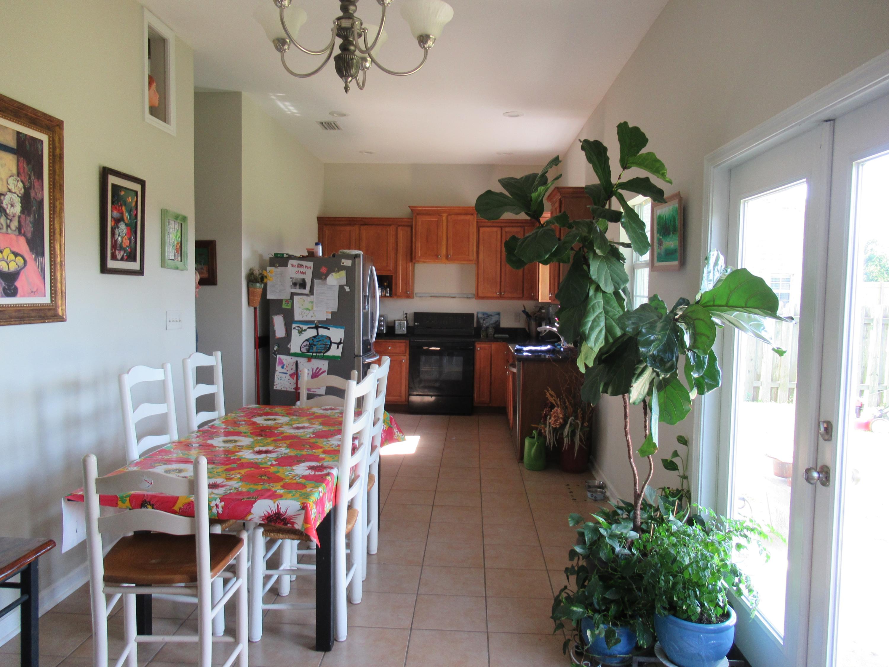 305 Tropical Way Freeport, FL 32439 - Photo 4 of 17 a dining room filled with furniture and a potted plant