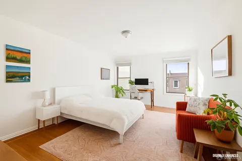 a bedroom with a bed and a couch