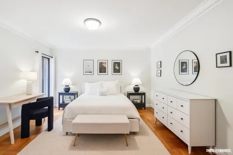 a bedroom with furniture and a mirror