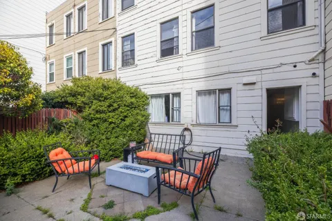 a view of a patio with couches table and chairs and potted plants