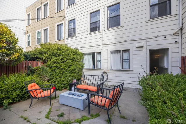a view of a patio with couches table and chairs and potted plants