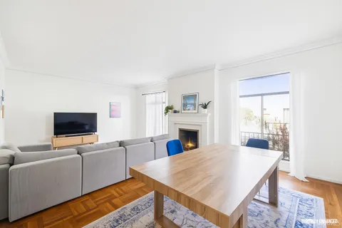 a living room with furniture flat screen tv and a fireplace