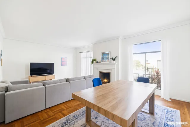 a living room with furniture flat screen tv and a fireplace