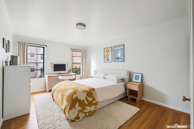 a bed room with a bed and a tv