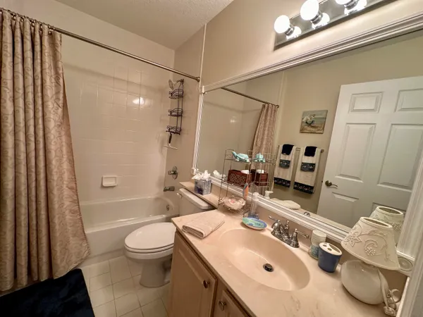 a bathroom with a sink toilet tub and shower