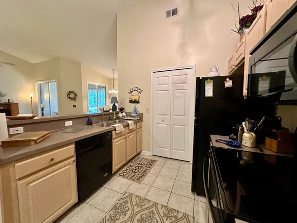 a kitchen with a sink appliances and cabinets