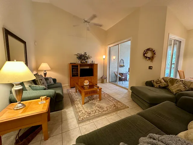 a living room with furniture and a lamp