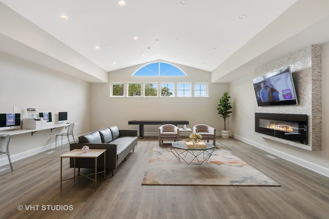 66 Sterling Circle, Unit 101 Wheaton, IL 60189 - Photo 8 of 14 a living room with furniture and a fireplace