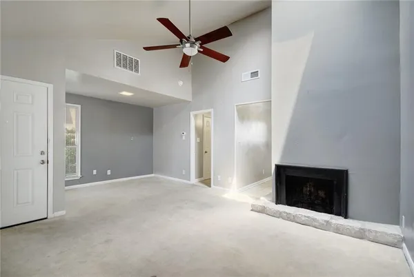 a view of an empty room with a fireplace