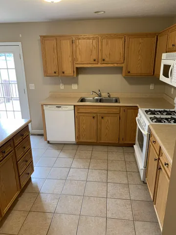 a kitchen with a stove top oven sink and cabinets
