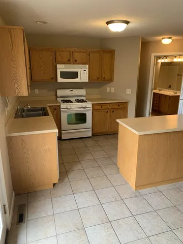 a kitchen with cabinets a sink and appliances