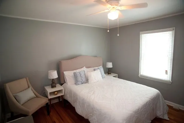 a bedroom with a bed and a chair