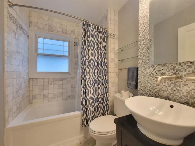 a bathroom with a bathtub and toilet