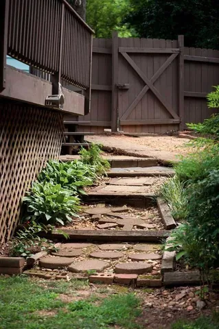 a view of backyard with wooden fence