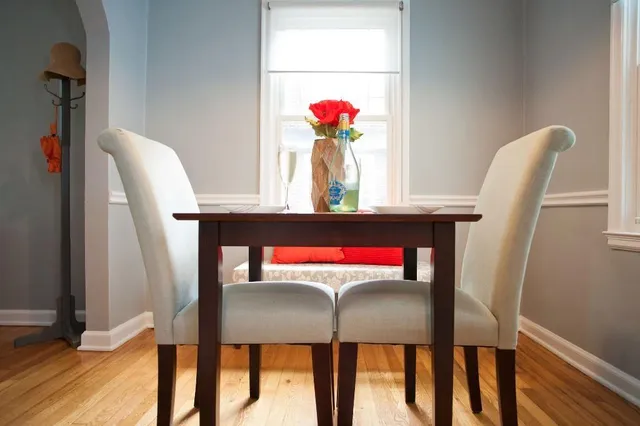 a view of a dining room with furniture and wooden floor