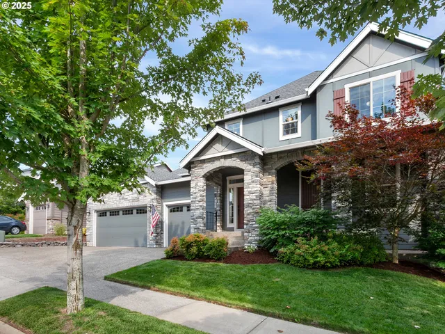 a front view of a house with a yard and garage
