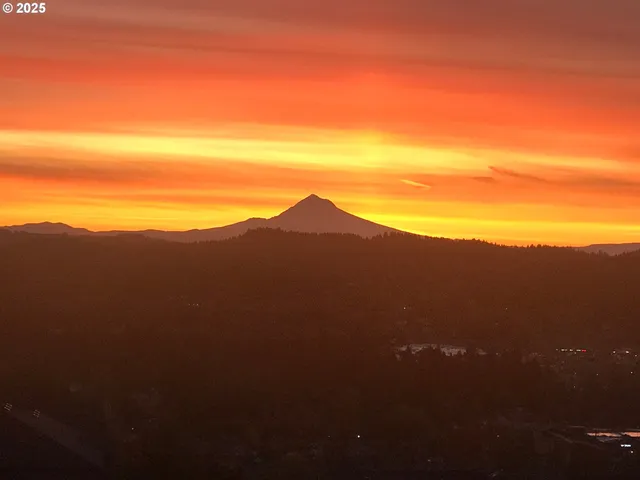 a view of a mountain range with a cloudy sky