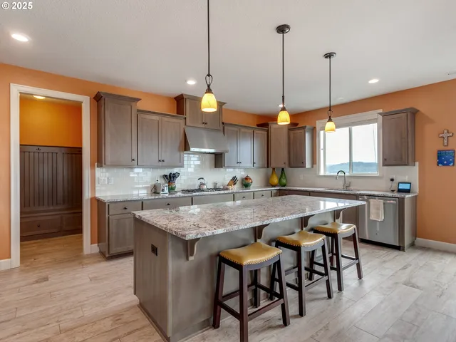 a kitchen with a table chairs sink and cabinets
