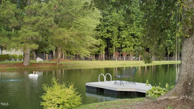 an aerial view of a house with a garden and lake view