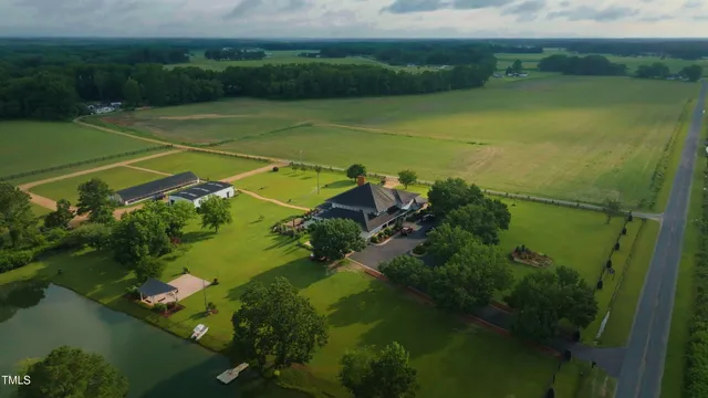 a aerial view of a house with a swimming pool and a yard