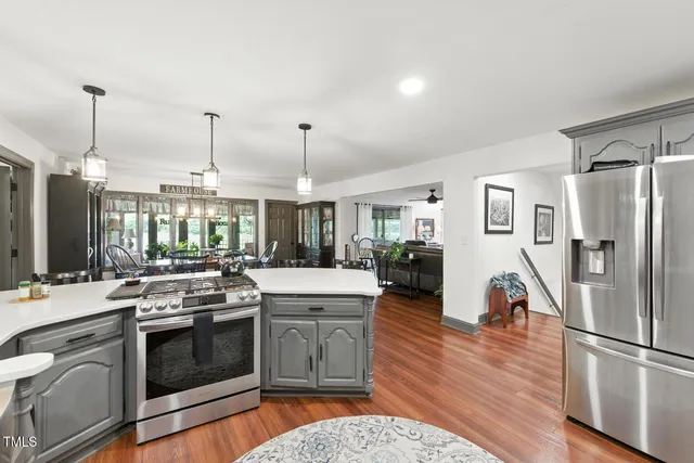 a bathroom with a granite countertop sink mirror vanity and toilet