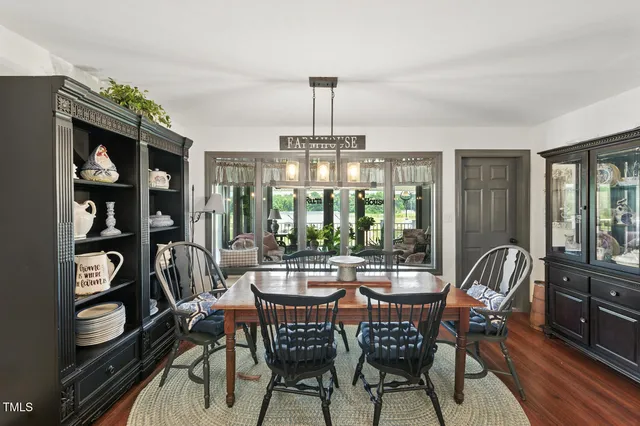 a spacious bedroom with a bed a chandelier and a window