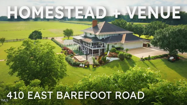 an aerial view of a house with a garden and lake view