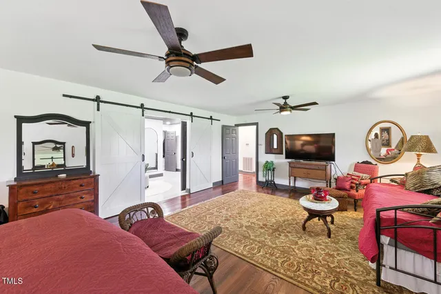 a view of a hallway with wooden floor and stairs
