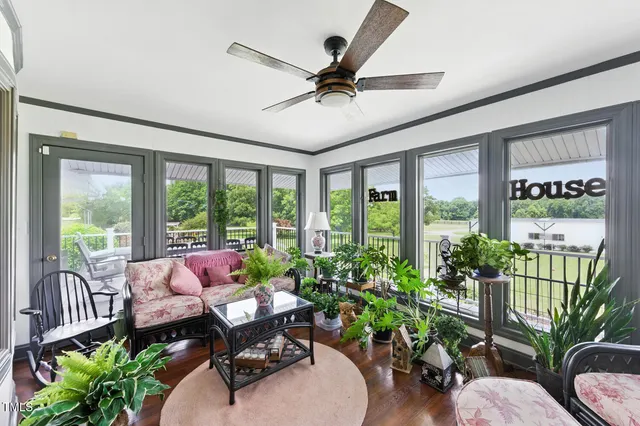 a bedroom with a bed a ceiling fan and a dresser