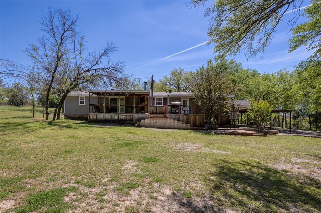 1701 Central Road Weatherford, TX 76088 - Photo 36 of 40 Rear view of the yard and home with a covered back porch.