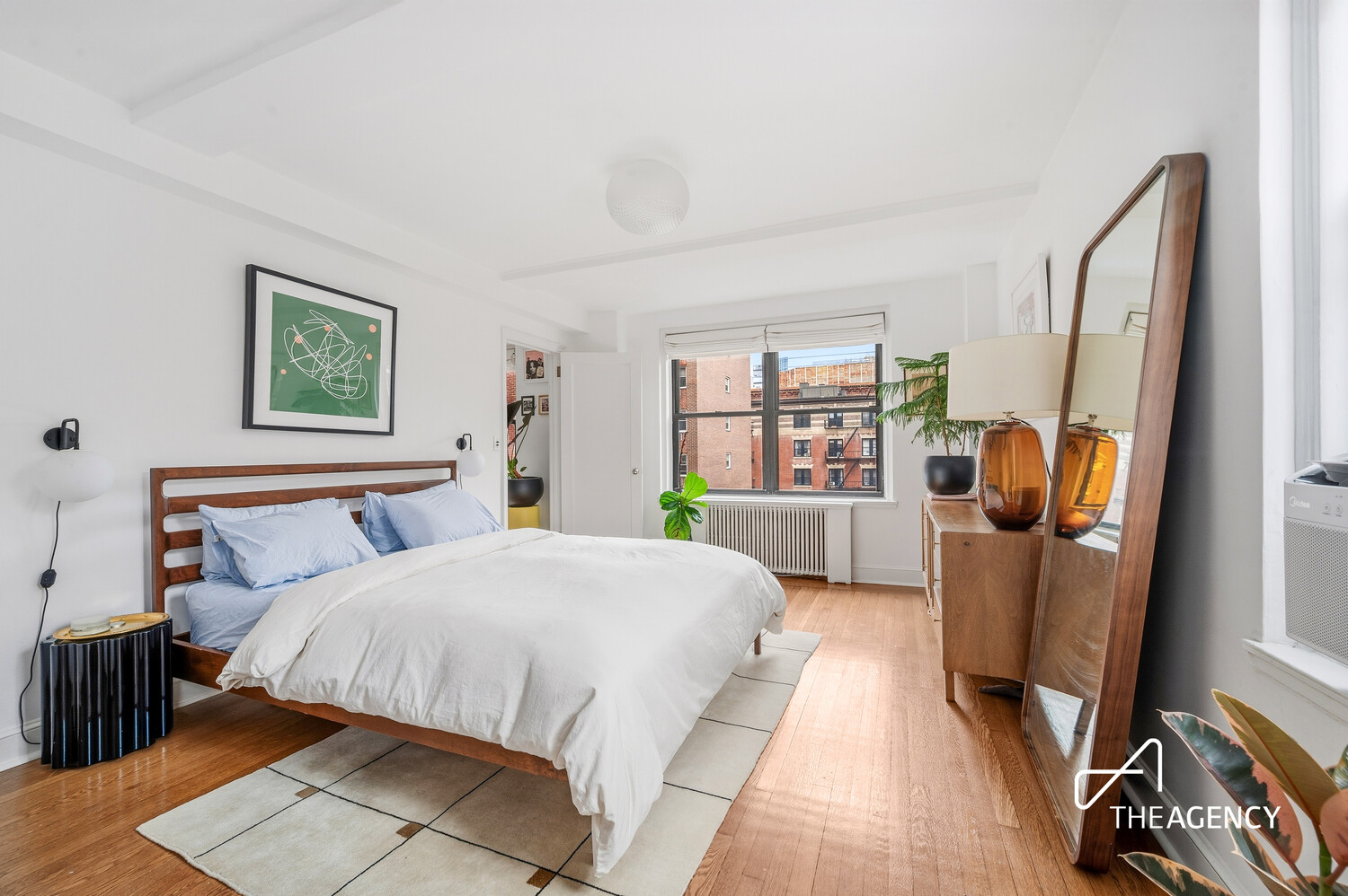 140 East 28th Street, Unit 7H Manhattan, NY 10016 - Photo 5 of 7 a bedroom with a bed and a large window