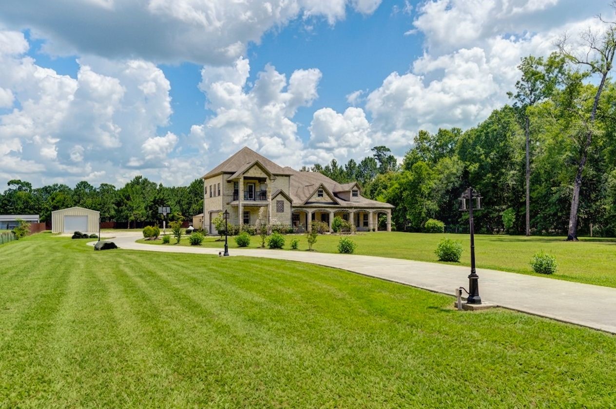 21038 Angus Drive Cleveland, TX 77328 - Photo 7 of 49 a view of a house with a big yard and a fountain