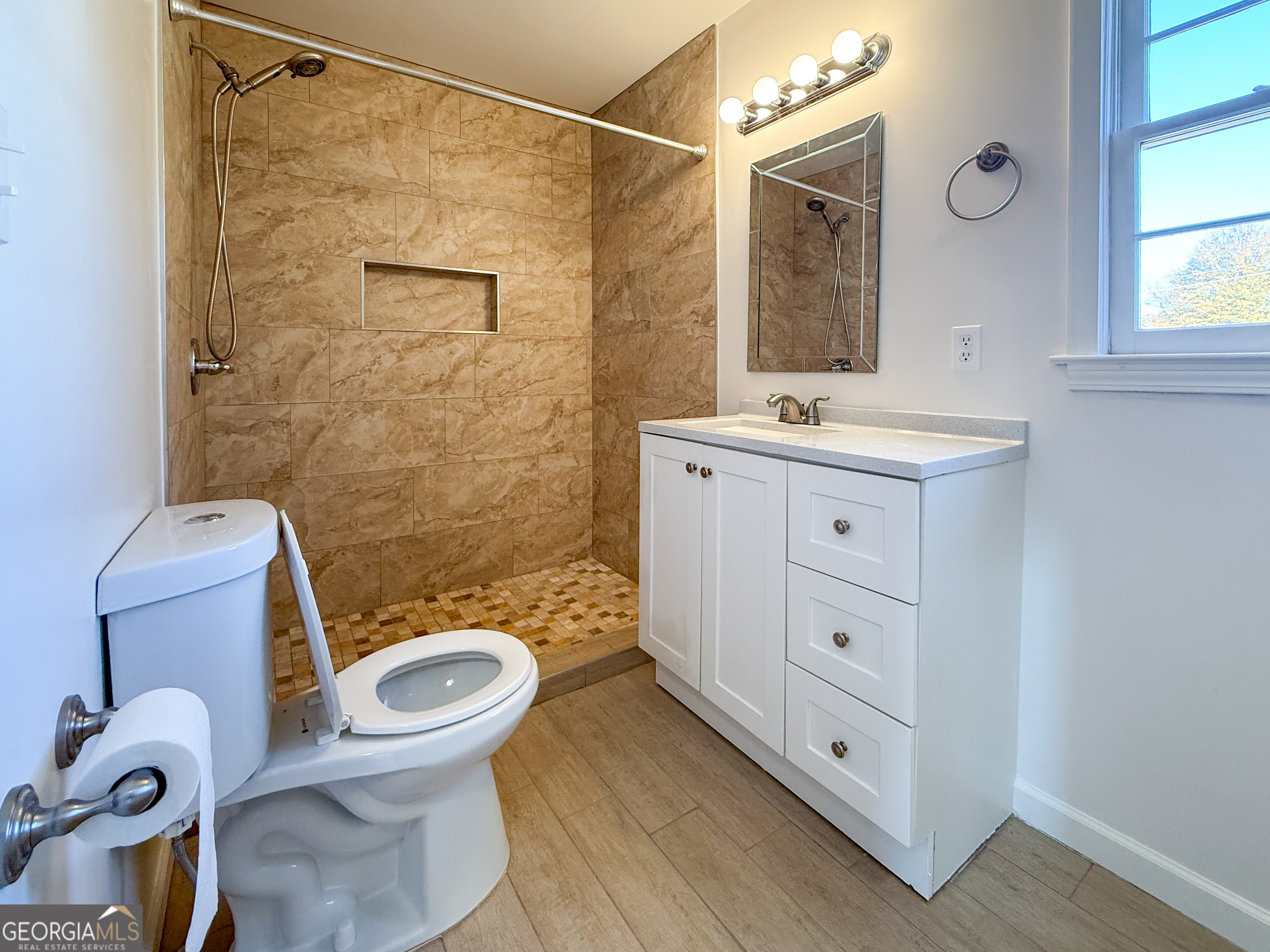 239 East Doyle Street Toccoa, GA 30577 - Photo 13 of 20 a bathroom with a sink a toilet and shower