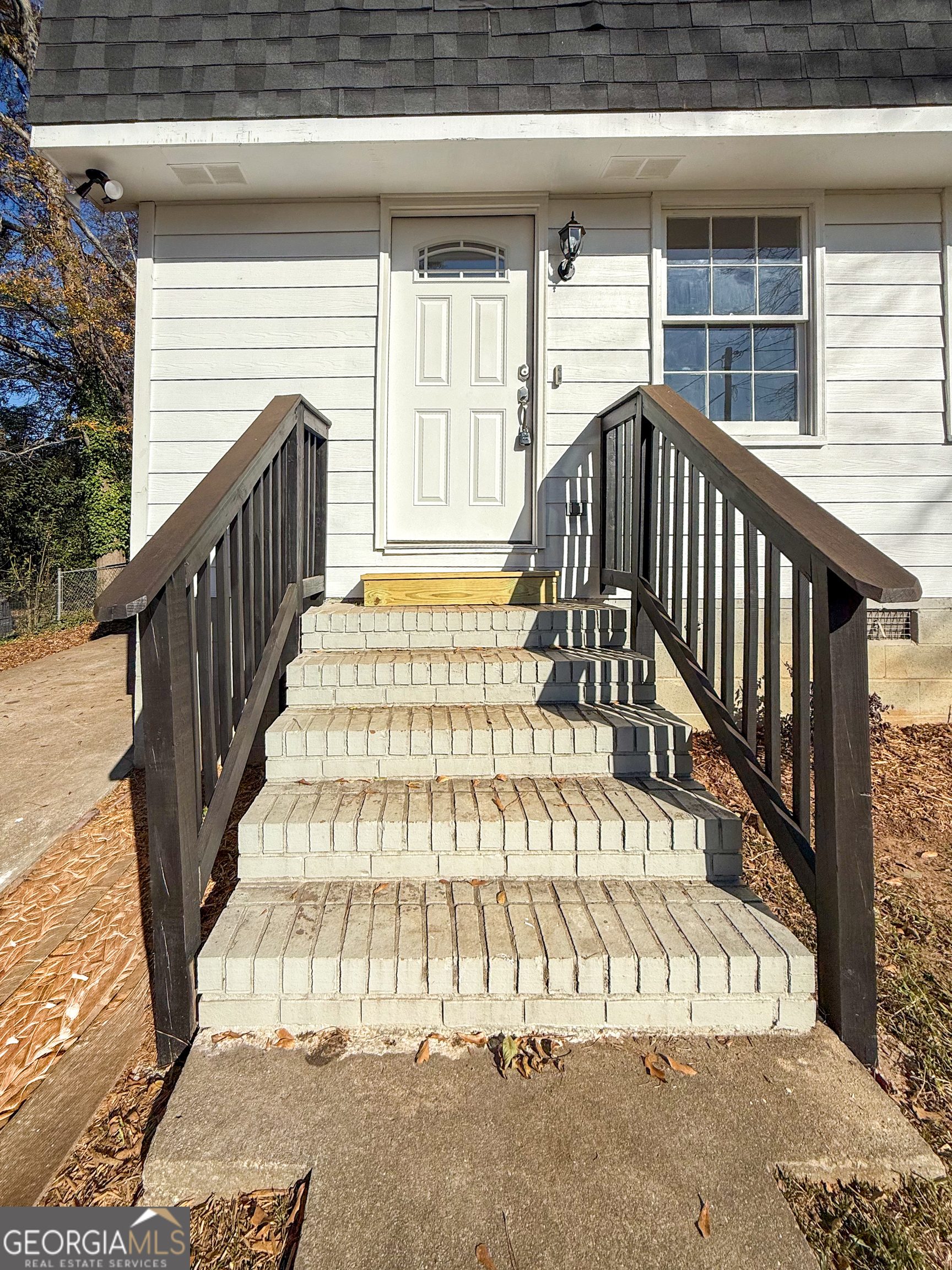 239 East Doyle Street Toccoa, GA 30577 - Photo 2 of 20 a view of entryway with wooden stairs