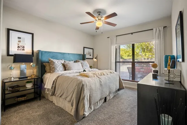 a kitchen with stainless steel appliances granite countertop a stove a sink dishwasher a dining table and chairs with wooden floor