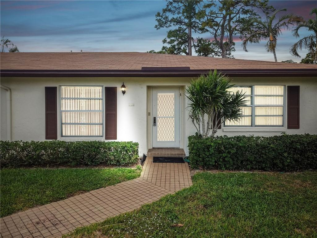 5348 Privet Place, Unit D Delray Beach, FL 33484 - Photo 1 of 60 a front view of a house with garden