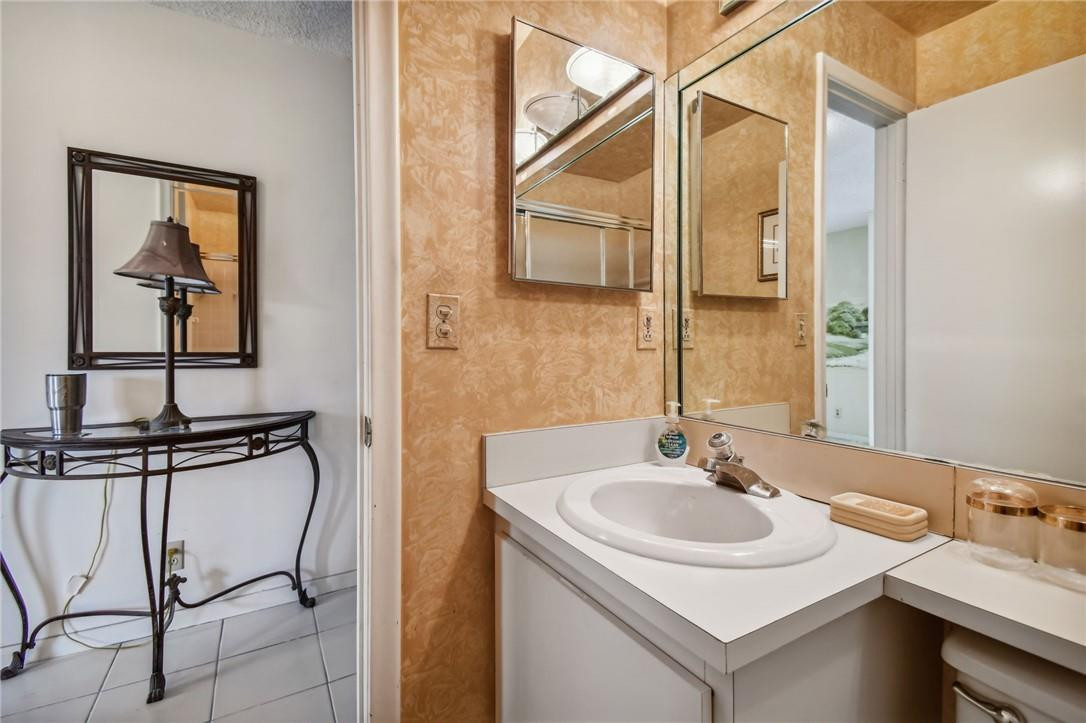5348 Privet Place, Unit D Delray Beach, FL 33484 - Photo 15 of 60 a bathroom with a sink and a mirror