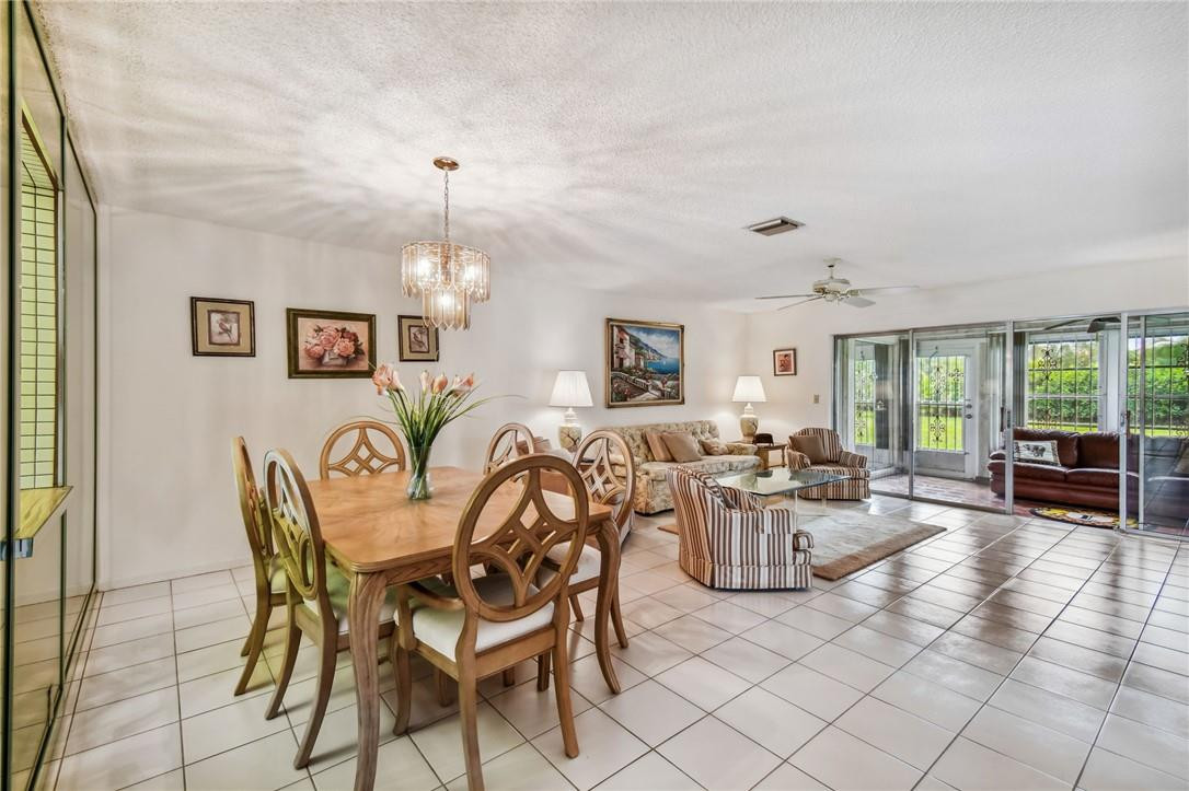 5348 Privet Place, Unit D Delray Beach, FL 33484 - Photo 17 of 60 a dining room with furniture a chandelier and window