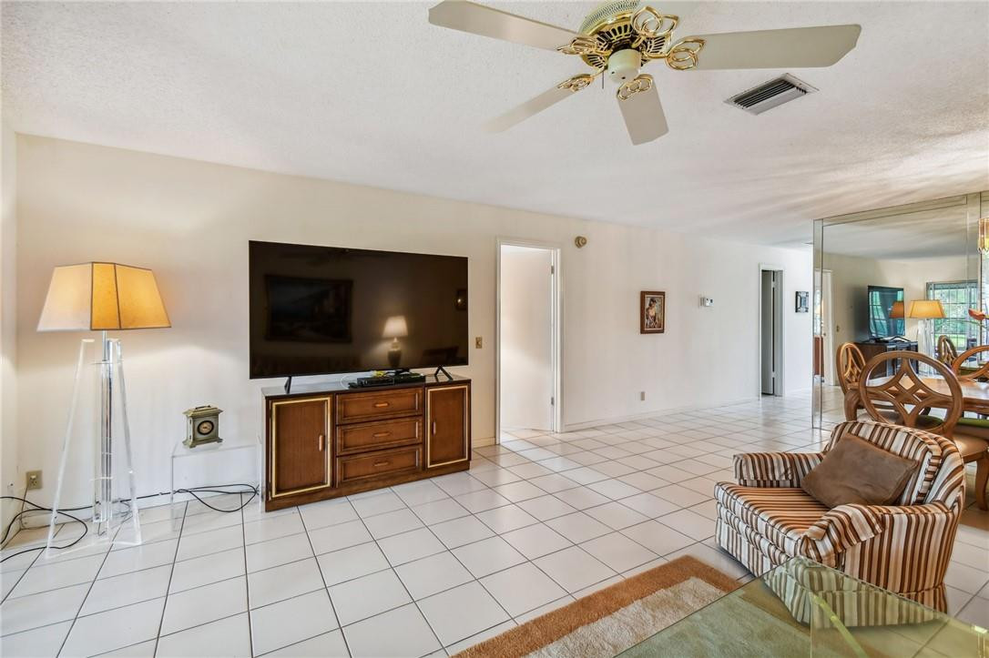 5348 Privet Place, Unit D Delray Beach, FL 33484 - Photo 20 of 60 a living room with furniture and a flat screen tv