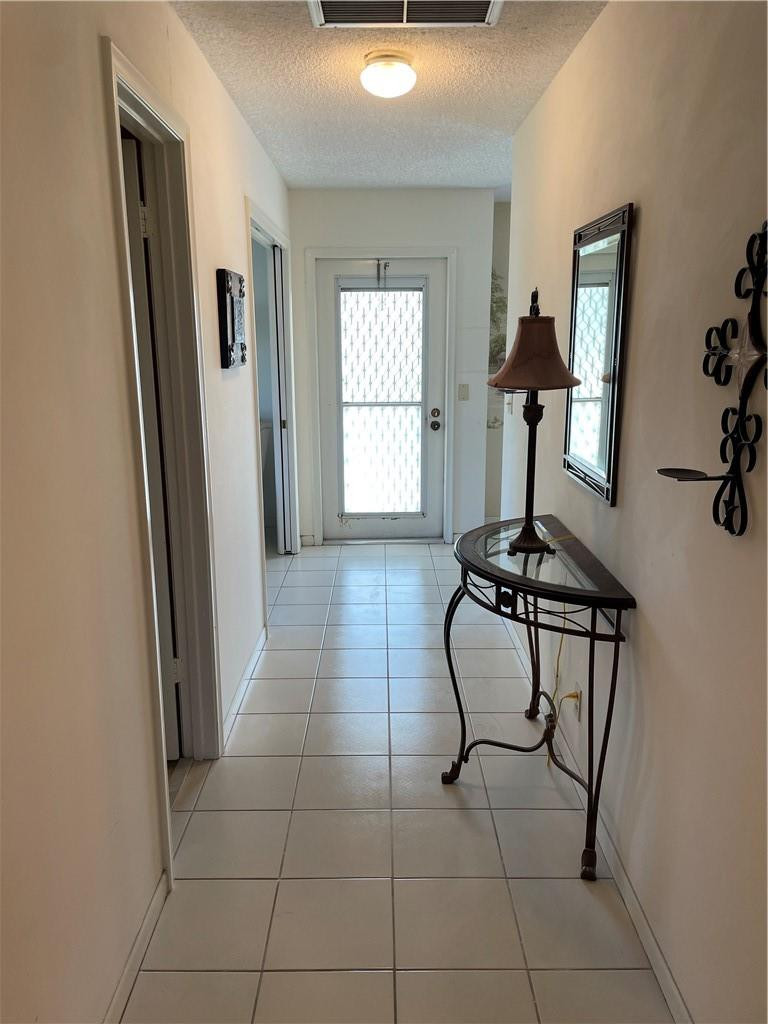 5348 Privet Place, Unit D Delray Beach, FL 33484 - Photo 26 of 60 a room with a mirror and gym equipment